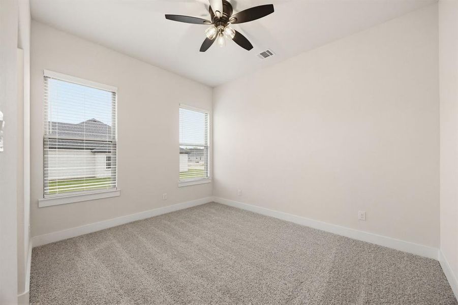 Neutral tone interior featuring plush grey carpeting and white baseboards