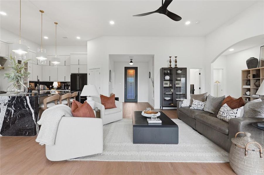 Open-concept living space featuring wood-finish flooring, recessed lighting, and a modern ceiling fan