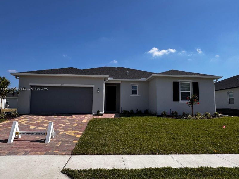 Front exterior of a new home in , Fort Myers, FL, highlighting curb appeal (Image 1). Front exterior of a new home in , Fort Myers, FL, highlighting curb appeal (Image 1).