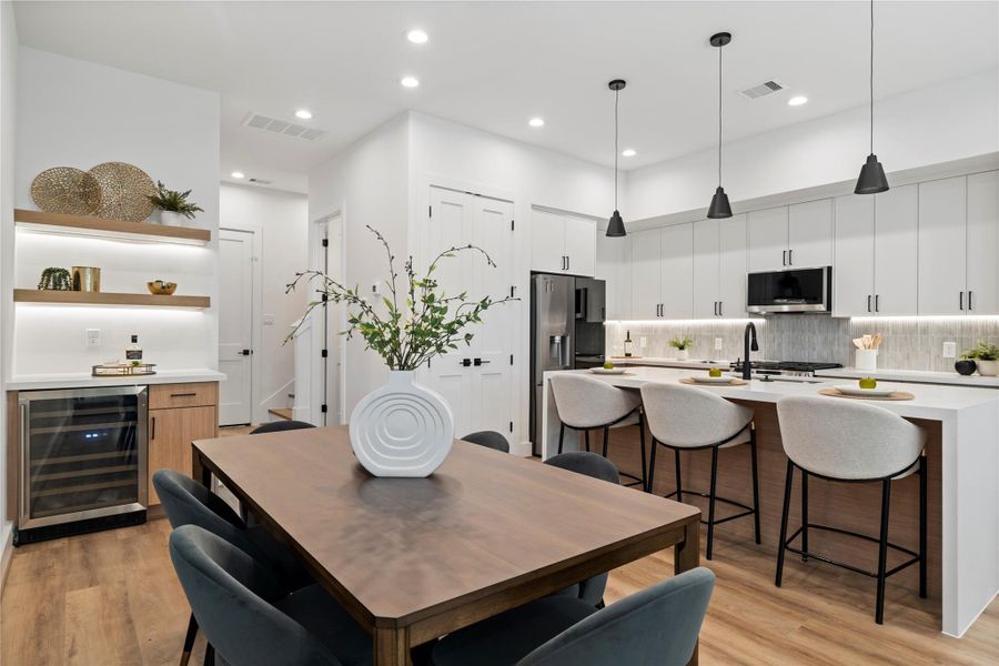 This space blends purpose and personality—imagine morning coffee at the dining table or evening wine poured straight from the built-in cooler. Clean lines, warm wood accents, and floating shelves add both storage and style, setting the tone for effortless hosting and everyday comfort. This space blends purpose and personality—imagine morning coffee at the dining table or evening wine poured straight from the built-in cooler. Clean lines, warm wood accents, and floating shelves add both storage and style, setting the tone for effortless hosting and everyday comfort.