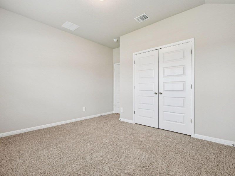 Unfurnished bedroom with carpet flooring and a closet Unfurnished bedroom with carpet flooring and a closet
