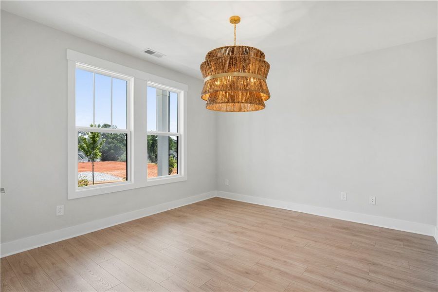 A warm glow emanates from the tiered chandelier in A warm glow emanates from the tiered chandelier in