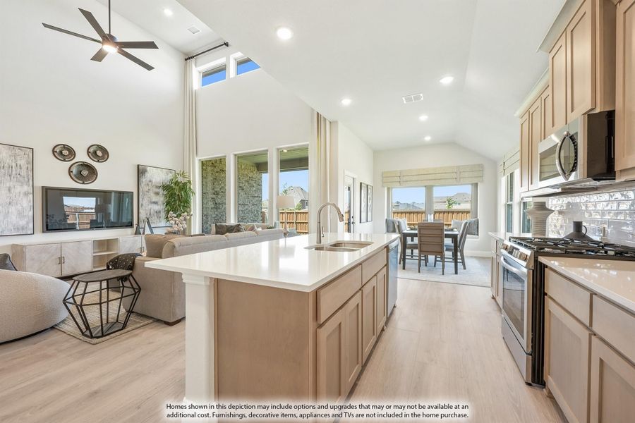 Open-concept kitchen with large island, stainless appliances, and vaulted ceiling overlooking living and dining areas