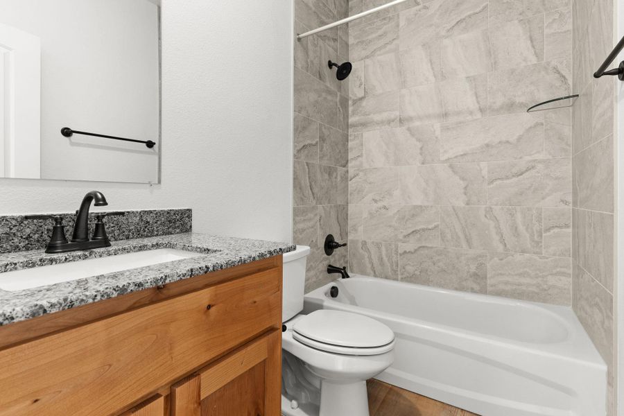 Full bath with vanity, shower combination, and toilet Full bath with vanity, shower combination, and toilet