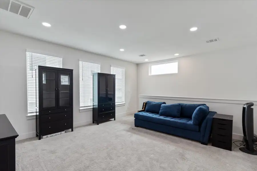 Living room featuring light colored carpet and recessed lighting