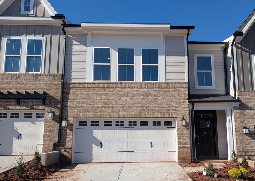 Front exterior of a new home in Ovation at Sweetbrier, Durham, NC, highlighting curb appeal (Image 1).