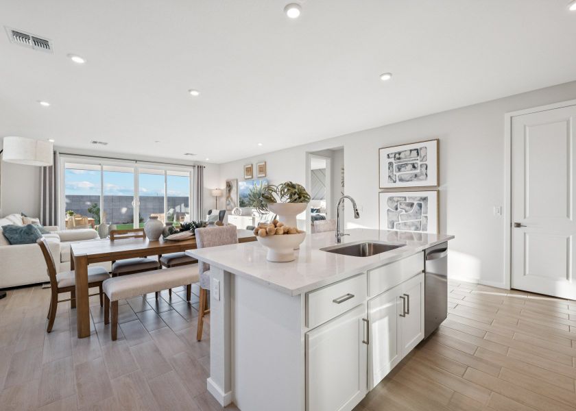 A kitchen with a table and chairs. A kitchen with a table and chairs.