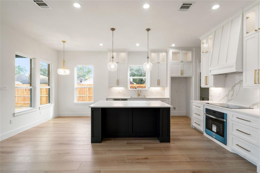 Elegant kitchen featuring a spacious island.
