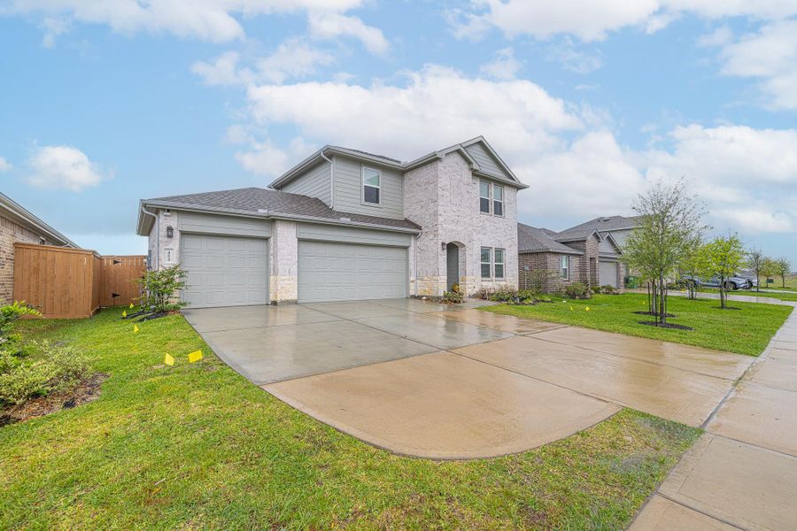 Front exterior of a new home in River Ranch Meadows, Dayton, TX, highlighting curb appeal (Image 2). Front exterior of a new home in River Ranch Meadows, Dayton, TX, highlighting curb appeal (Image 2).