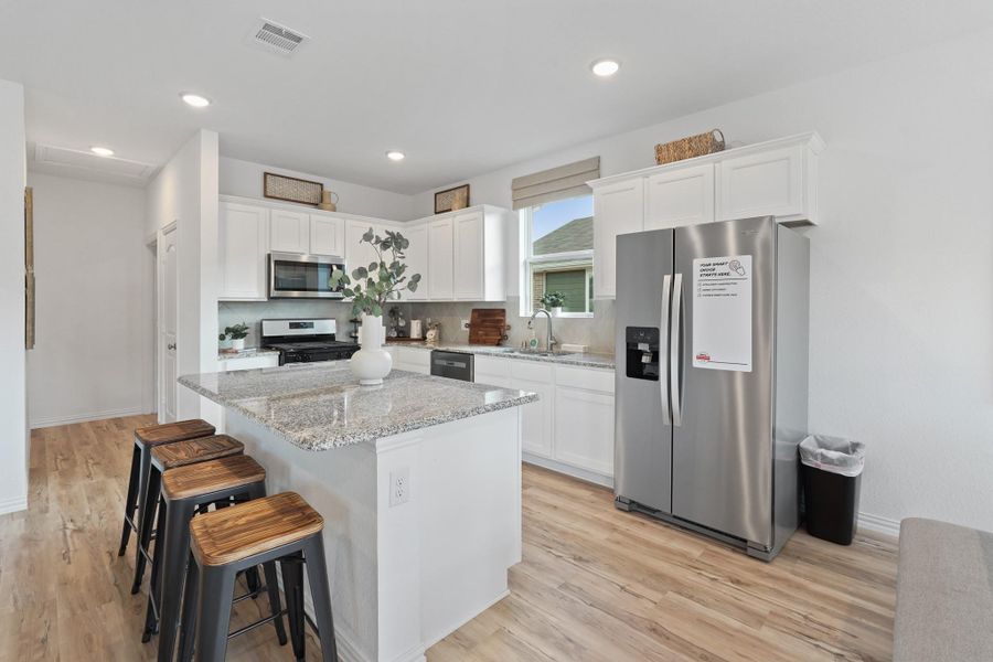 Every detail has been thoughtfully designed, from the state-of-the-art appliances that make meal prep a breeze, to the charming backsplash that adds a touch of personality.