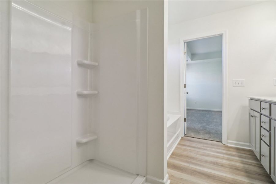 This bright bathroom features a clean shower and s This bright bathroom features a clean shower and s