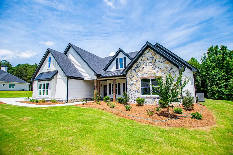 Front exterior of a new home in WOODMONT RESERVE, Roopville, GA, highlighting curb appeal (Image 29).