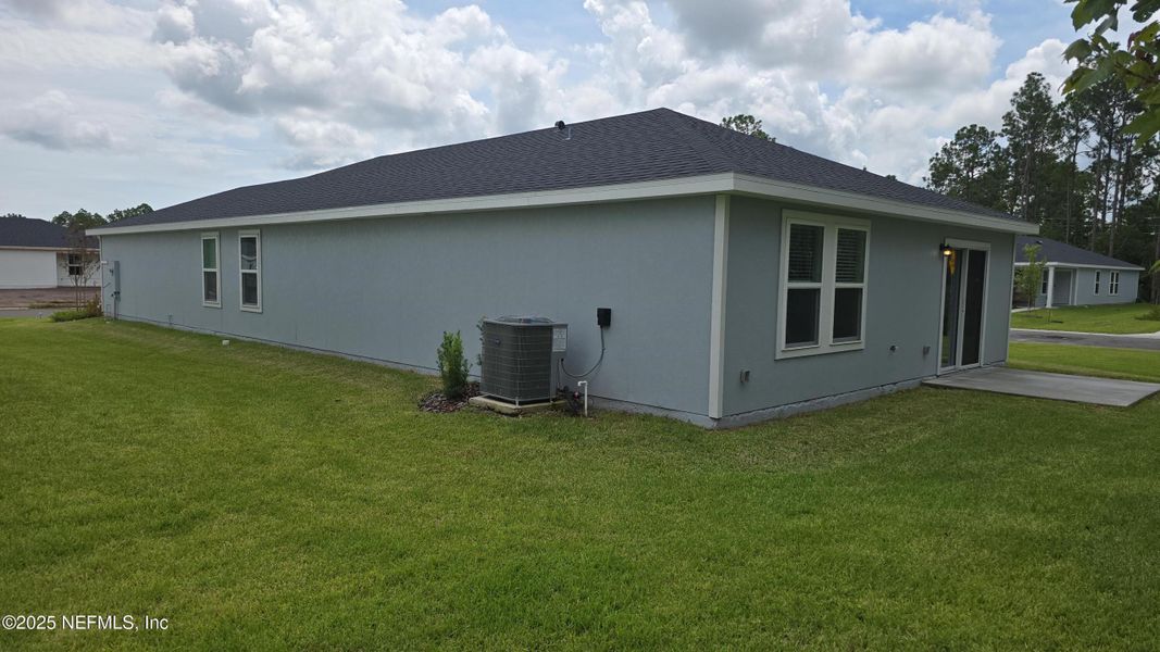 Front exterior of a new home in Flagler Village - Classic Series, Palm Coast, FL, highlighting curb appeal (Image 24). Front exterior of a new home in Flagler Village - Classic Series, Palm Coast, FL, highlighting curb appeal (Image 24).