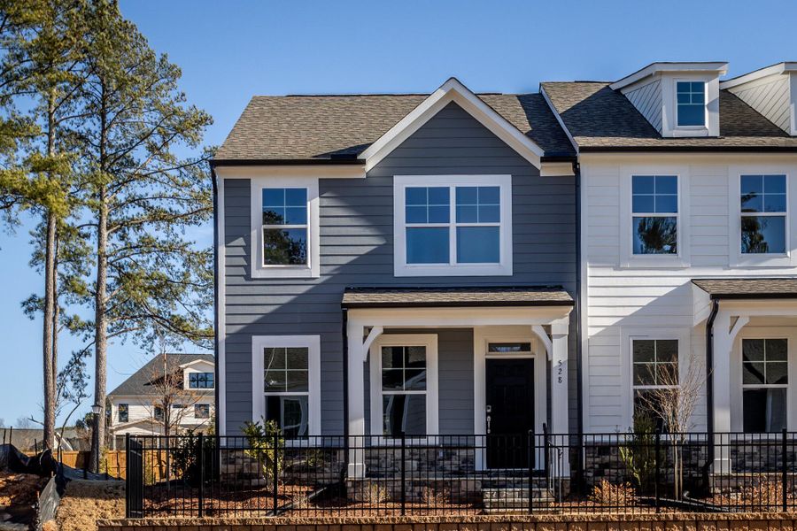 Front exterior of a new home in Enclave at Traditions Townhomes, Wake Forest, NC, highlighting curb appeal (Image 2). Front exterior of a new home in Enclave at Traditions Townhomes, Wake Forest, NC, highlighting curb appeal (Image 2).