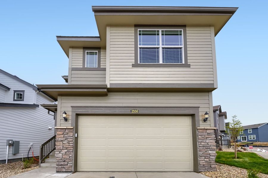Front exterior of a new home in Preserve at Mesa Creek, Colorado Springs, CO, highlighting curb appeal (Image 1). Front exterior of a new home in Preserve at Mesa Creek, Colorado Springs, CO, highlighting curb appeal (Image 1).