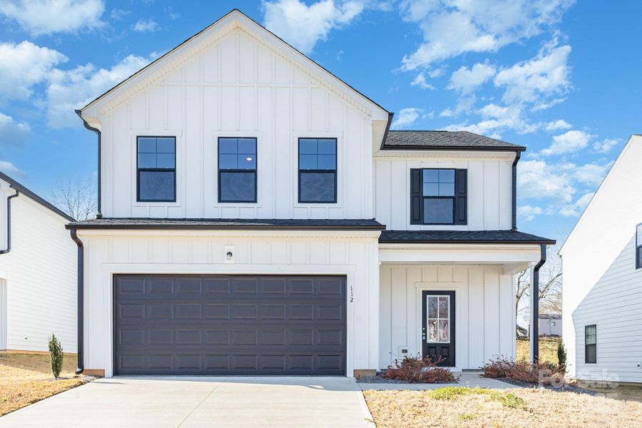 Front exterior of a new home in , Mooresville, NC, highlighting curb appeal (Image 1).