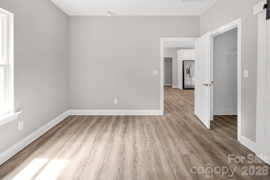 Primary Suite with walk in closet and en-suite bathroom.