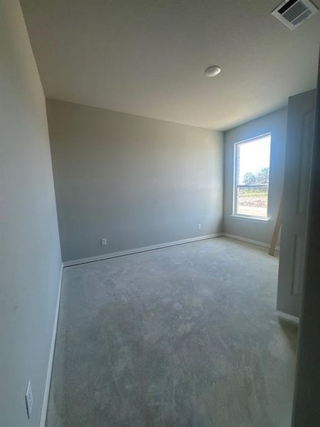 Unfurnished room featuring baseboards and concrete floors