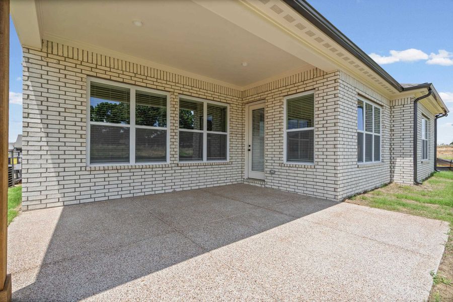Covered patio with a speckled concrete surface Covered patio with a speckled concrete surface