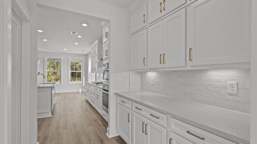 Established charm meets modern elegance in this first-rate butler's pantry by DRB Homes