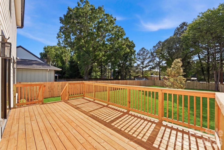 Backyard deck. Note: The lawn has been recently seeded, and photography has been digitally enhanced to represent the yard at full, established growth. Backyard deck. Note: The lawn has been recently seeded, and photography has been digitally enhanced to represent the yard at full, established growth.