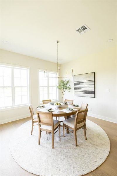 Dining area featuring multiple windows, recessed lighting, and a contemporary chandelier