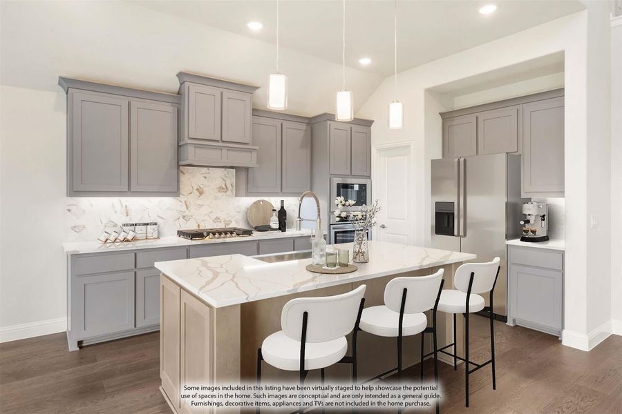 Kitchen with gray cabinets, marble backsplash, center island with white barstools, and pendant lights overhead Kitchen with gray cabinets, marble backsplash, center island with white barstools, and pendant lights overhead