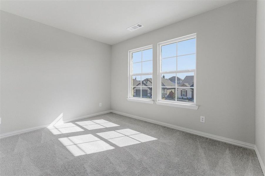 Unfurnished room featuring light carpet