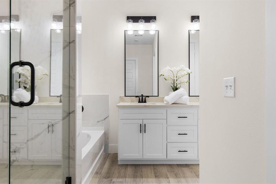 Bathroom with plus walk in shower, vanity, and hardwood / wood-style flooring