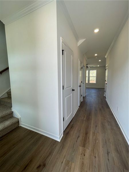 This spacious hallway features elegant crown moldi