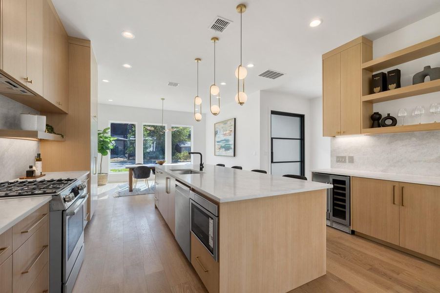 Kitchen featuring open shelves, light brown cabinets, tasteful backsplash, stainless steel appliances, and light wood-style flooring Kitchen featuring open shelves, light brown cabinets, tasteful backsplash, stainless steel appliances, and light wood-style flooring