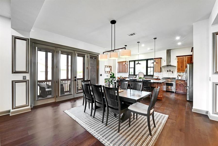 Dining area featuring dark wood-type flooring and recessed lighting