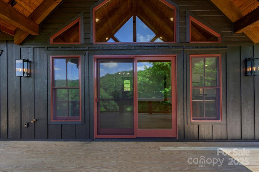 Over 1,200 square feet of outdoor space including main level porte-cochere, covered porches with majestic, private mountain & neighborhood pond views