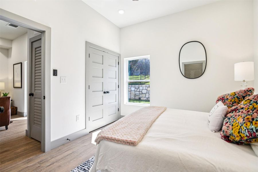 Bedroom featuring light wood-style floors and baseboards