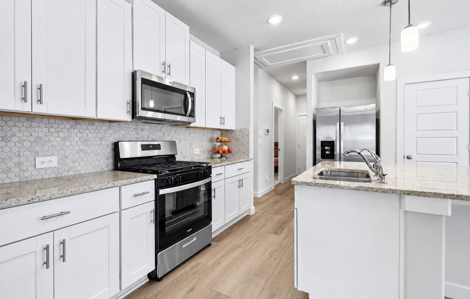 The spacious kitchen features a large island, stainless steel appliances, and ample cabinetry. The spacious kitchen features a large island, stainless steel appliances, and ample cabinetry.