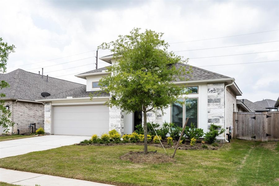 Charming single-story home with a modern exterior, featuring a two-car garage and well-maintained landscaping. The front yard includes a small tree and neatly arranged shrubs, enhancing curb appeal. Located in a quiet neighborhood with easy access to amenities. Charming single-story home with a modern exterior, featuring a two-car garage and well-maintained landscaping. The front yard includes a small tree and neatly arranged shrubs, enhancing curb appeal. Located in a quiet neighborhood with easy access to amenities.