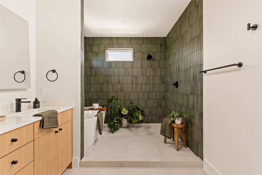 Full bath featuring vanity, a walk in shower, and light tile patterned flooring