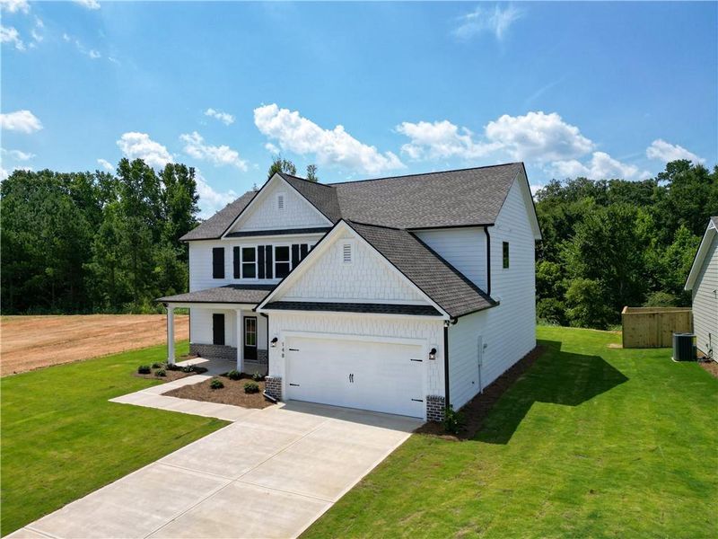 Front exterior of a new home in Harmony Farms, Eatonton, GA, highlighting curb appeal (Image 24).