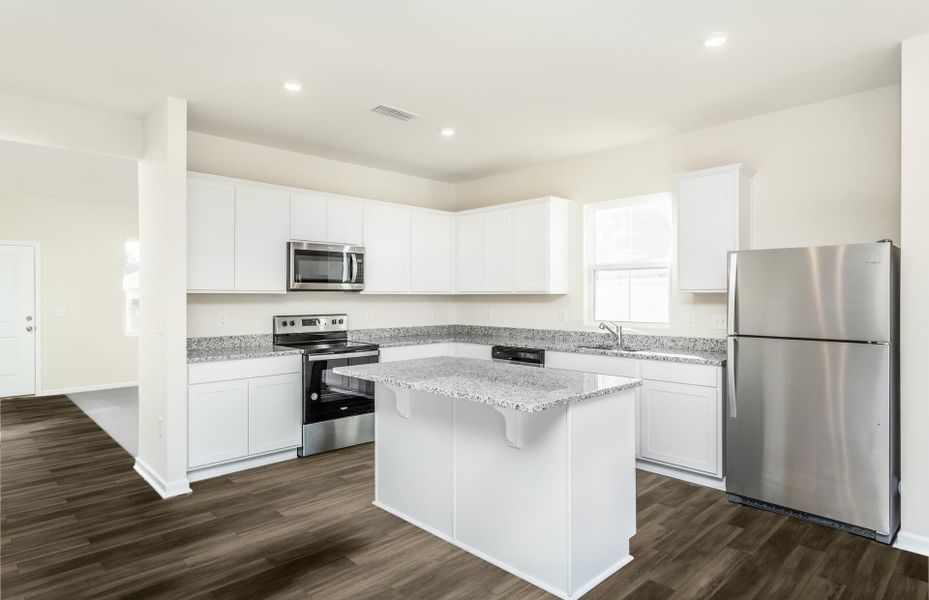 Package A Kitchen with beautiful white cabinets and granite countertops.