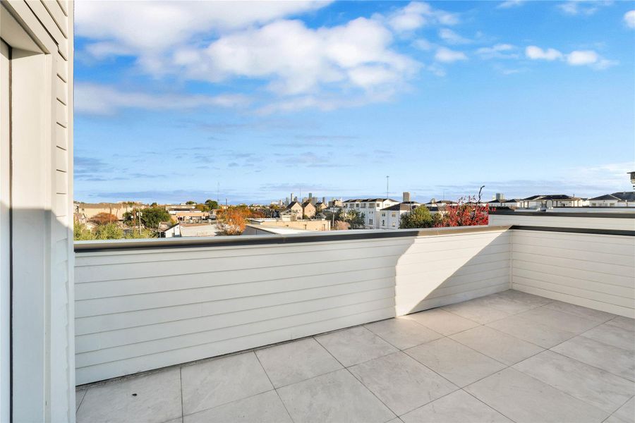 Rooftop terrace with downtown views. Enjoy gatherings in this beautiful outdoor space, complete with gas and power connections for a grill or outdoor kitchen.