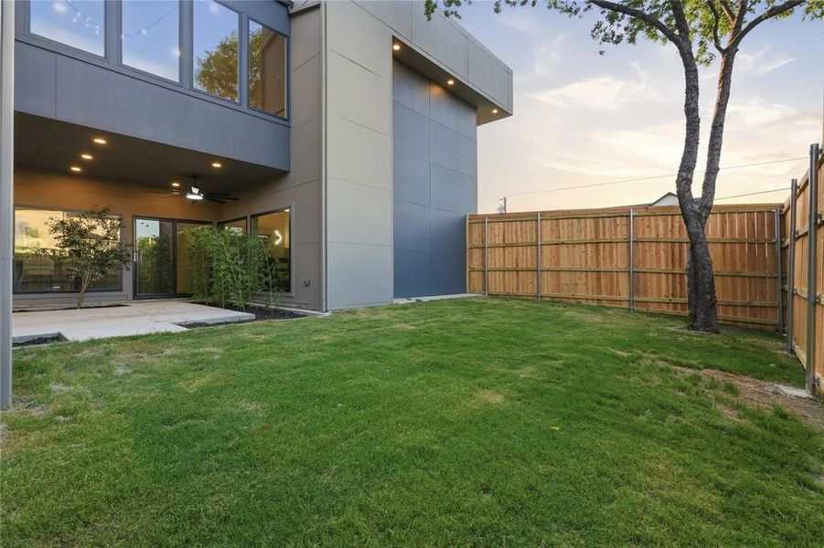Expansive lawn with a new wood privacy fence