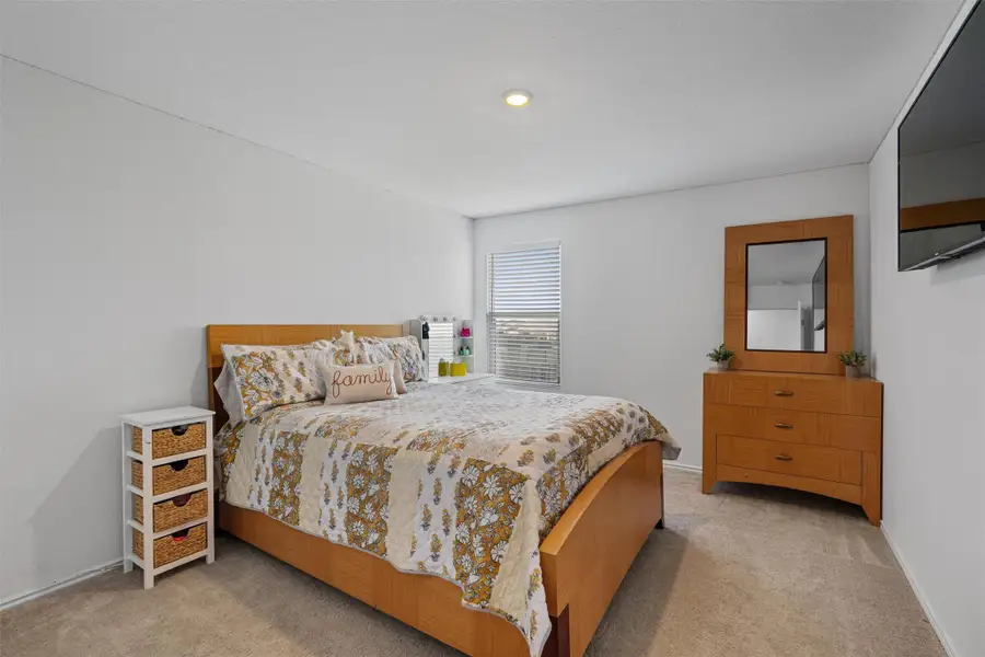 Carpeted bedroom featuring baseboards
