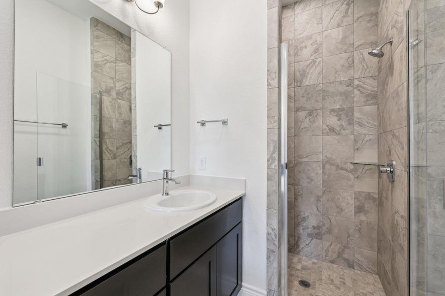 Bathroom with a stall shower and vanity