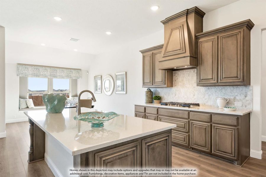 Kitchen with dark wood cabinets, large island, quartz countertops, and decorative range hood over gas cooktop Kitchen with dark wood cabinets, large island, quartz countertops, and decorative range hood over gas cooktop