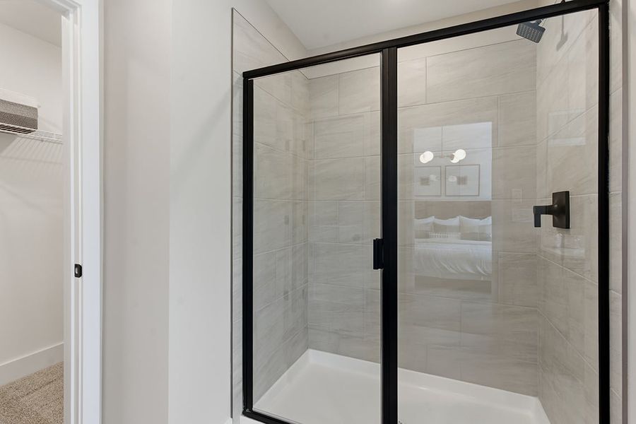 A shower with a glass door.