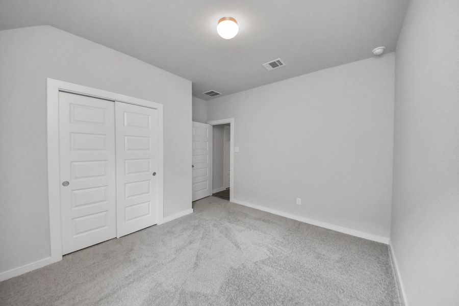 Generously sized secondary bedrooms featuring spacious closets, soft and inviting carpeting underfoot, large windows allowing plenty of natural light, and the added touch of privacy blinds for your personal retreat. Sample photo of completed home with similar floor plan. Actual colors and selections may vary. Generously sized secondary bedrooms featuring spacious closets, soft and inviting carpeting underfoot, large windows allowing plenty of natural light, and the added touch of privacy blinds for your personal retreat. Sample photo of completed home with similar floor plan. Actual colors and selections may vary.