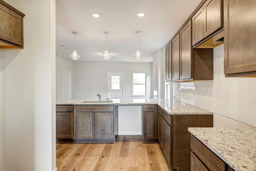 The Caldwell- Kitchen into the Family Room. Home under construction. Sample floor plan photo used for illustrative purposes only. Upgrades, selections options, windows and colors may vary. The Caldwell- Kitchen into the Family Room. Home under construction. Sample floor plan photo used for illustrative purposes only. Upgrades, selections options, windows and colors may vary.