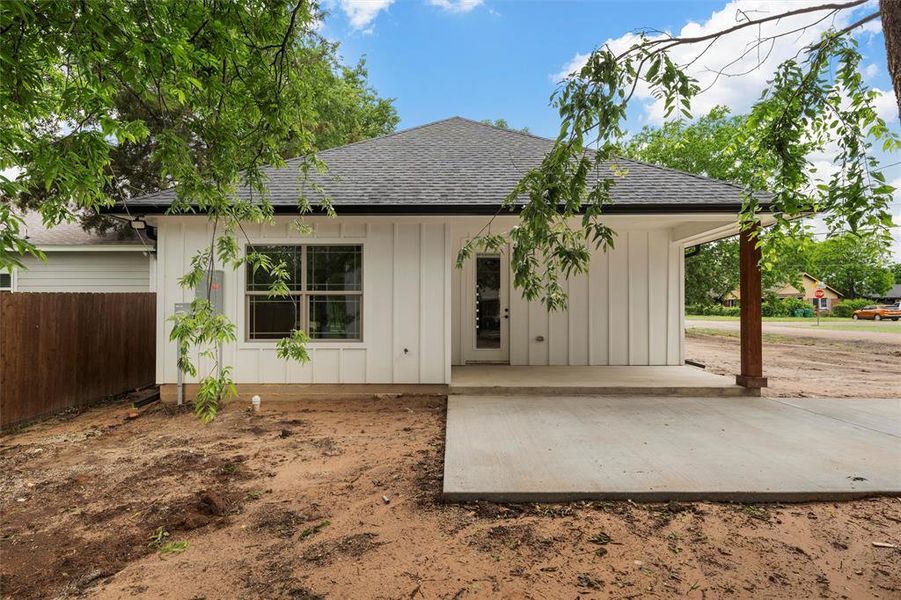 Single story home featuring a shingled roof, fence, and board and batten siding