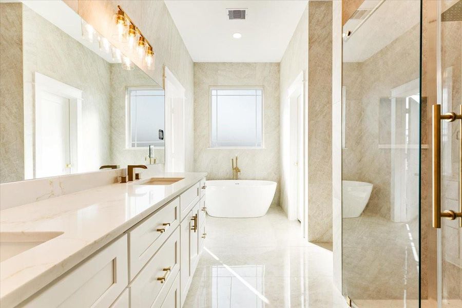 Another angle of the primary bathroom highlighting the oversized vanity and luxurious design. Another angle of the primary bathroom highlighting the oversized vanity and luxurious design.