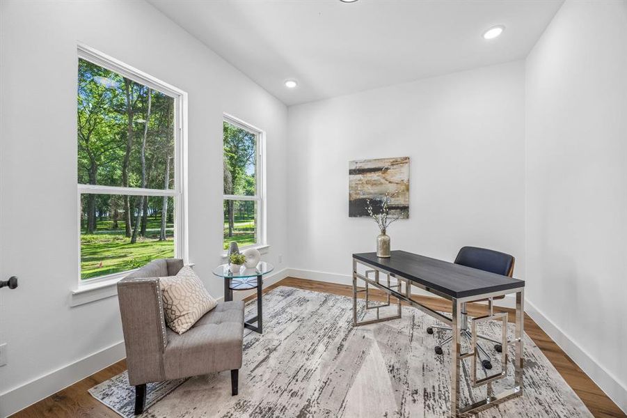 Bright home office featuring two large windows and recessed ceiling lighting